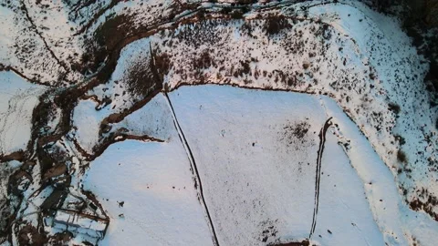 Bird eye view from drone of snow covered mountain top flat ground. Video stock 157971658