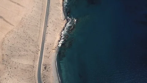 Bird eye view of green foaming ocean waves crushing against the coastline Stock Footage 94070505