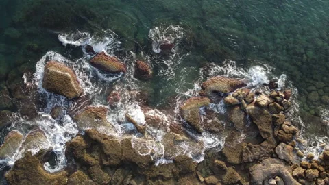Bird Eye View of Ocean or Sea Waves Splash Against Rocks or Stones and Foaming Stock Footage 168170952