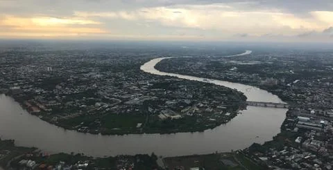 Bird eye view from plane window: Ho Chi Minh City with meandering SaigonRiver Stock Photos