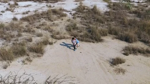 Bird eye view from remote control flying drone of two asian boy play together on Stock Footage 71900983