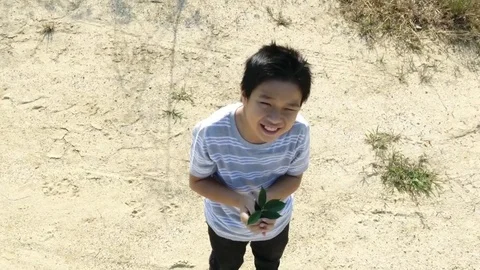 Bird eye view from remote control flying drone of young asian boy carry young se Stock Footage 71901162