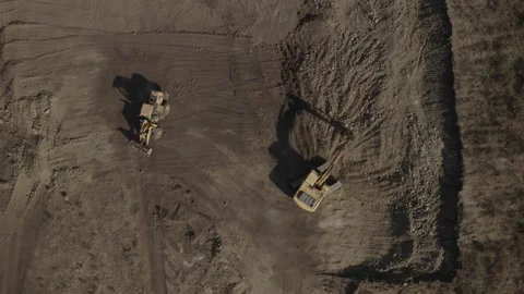 Bird eye view of tractor and excavator doing earthwork at construction site Видео 219799255