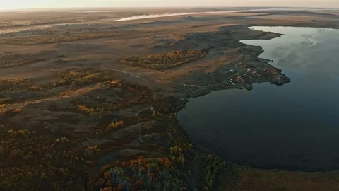 Bird eye view of valley, forests, fields and lake illuminated by setting sun Stock Footage 124113576