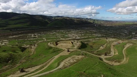 Bird eye view of wide green expanse with oil pumping machines Stock Footage 79427082