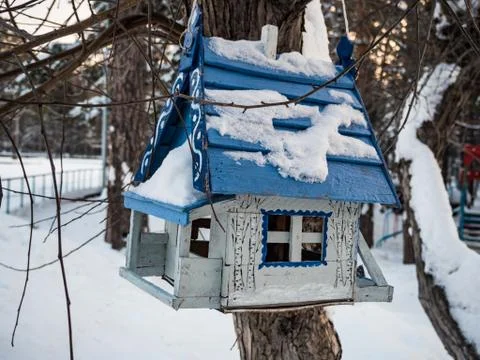 Bird feeder in the form of a house under the snow, Novosibirsk, Russia Stock Photos
