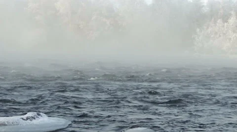 A bird flies over the winter river, mist Video stock 55527494