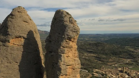 Bird flying high over large stack rock formation in Aguero, Spain Stock Footage 102514808