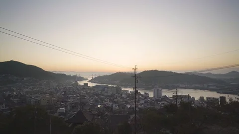 Bird Flying to Hold Cable with View of Onomichi Town, Inland Sea in Morning 스톡 동영상 128944065