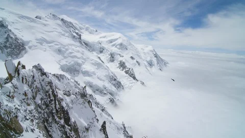 Bird flying in the sky over the snowy mountain of Chamonix Stock Footage 116789265