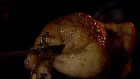 A bird roasted on a spit in an oven in close-up. Stock Footage 69090824