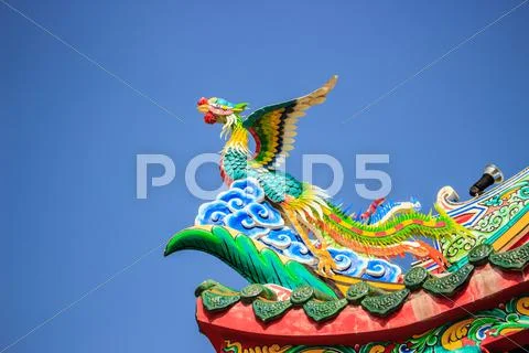 Bird statue in the coner roof Stock Photos