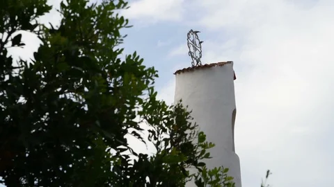 A bird takes flight from a bell tower roof on a sunny day. 库存影片 109231590