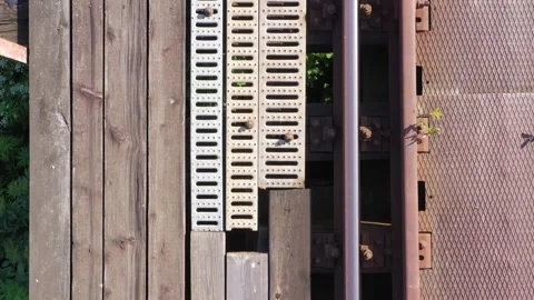 Bird view flying over railroads and board catwalk over  the bridge and river Video stock 277707457