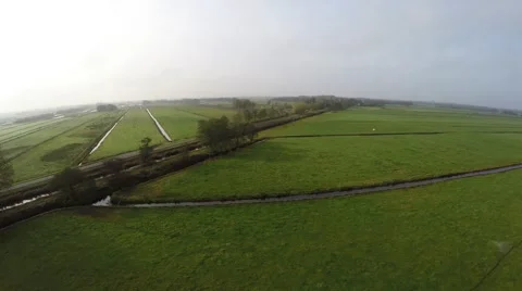 Bird view flying sideways slowly along a road over grasslands landscape 4k Stock Footage 57059190