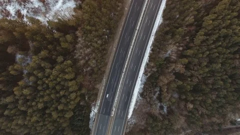 Bird view on a highway in the middle of woods with a single car, 4K Stock Footage 72840357