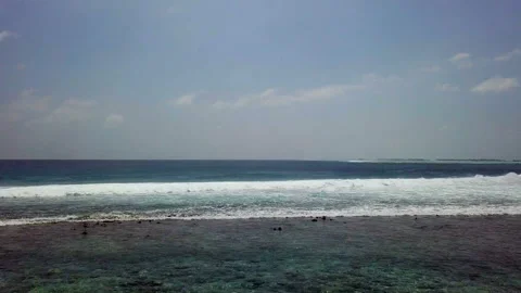 Bird view of the ocean wave on the reef in Maldives Видео 114522679