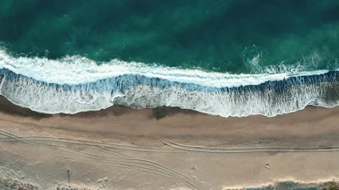 Bird view of ocean waves crashing into sandy beach Stock Footage 170692828