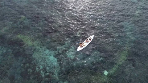 Bird view of two men paddling on kayak in turquoise water Stock Footage 106721114