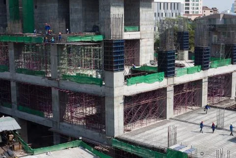 Bird-view workers work structure with cement  steel and metal in construction Stock Photos