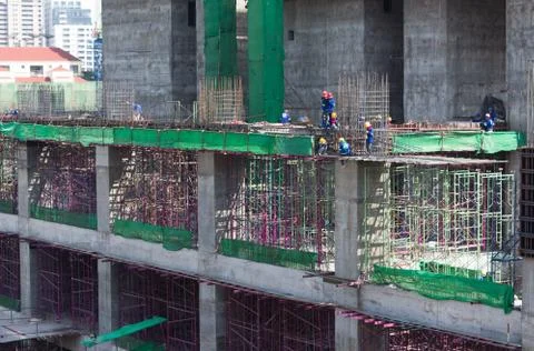 Bird-view workers work structure with cement  steel and metal in construction Stock Photos
