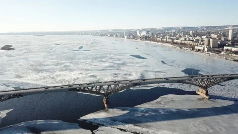 Bird's-eye bridge across the spring river and city Video stock 128284728