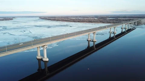 Bird's-eye bridge across the spring river and city Video stock 128284853