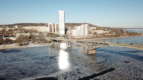 Bird's-eye bridge across the spring river and city Video stock 128284929