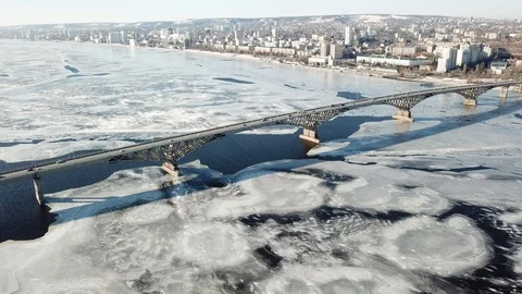 Bird's-eye bridge across the spring river and city Video stock 128285033