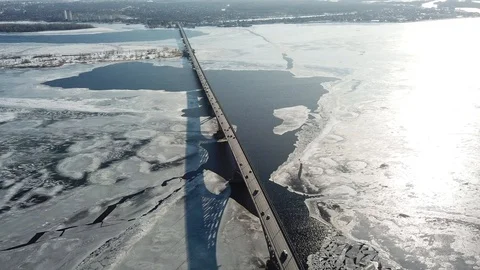 Bird's-eye bridge across the spring river and city Video stock 128285114