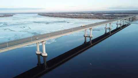 Bird's-eye bridge across the spring river and city Video stock 128285254