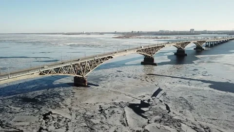 Bird's-eye bridge across the spring river and city Video stock 130406967