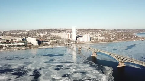 Bird's-eye bridge across the spring river and city Video stock 130407433