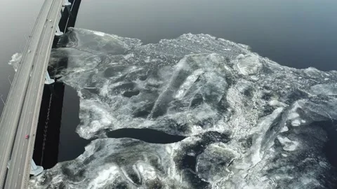 Bird's-eye bridge across the spring river and city Video stock 130410049