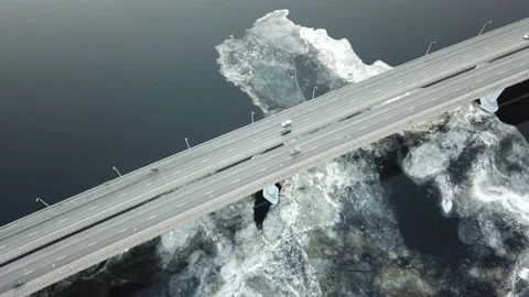 Bird's-eye bridge across the spring river and city Stock Footage 132244656
