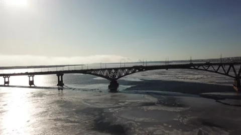 Bird's-eye bridge across the spring river and city Stock Footage 132354677