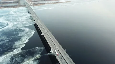 Bird's-eye bridge across the spring river and city Stock Footage 136651343