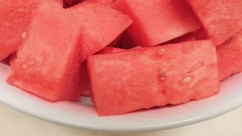 Birds Eye Close-up of Watermelon in a Ceramic Serving Bowl on a Wooden Turntable Stock Footage 79382794