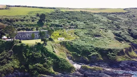 Birds Eye Drone Shot Arcing Right Over Cornwall Coast and Wedding Function 4 Stock Footage 320946574