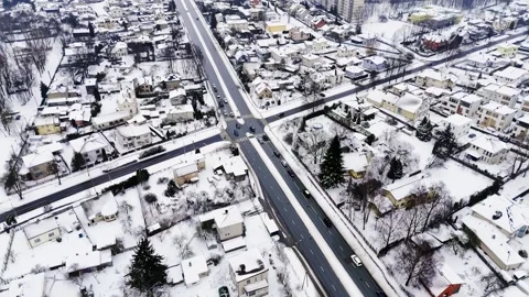 Bird’s-eye drone view of a four-way intersection in a quiet suburb, cars Stock Footage 328664548