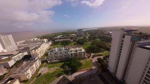 Bird's-eye perspective of beachfront property near sea with lush vegetation Stock Footage 345060786