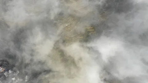 Bird's eye perspective of cloud covered rice terraces in rural China Stock Footage 109542593
