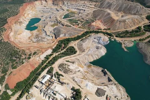 Bird's eye perspective of an open pit mine or a quarry. Human interference in Stock Photos
