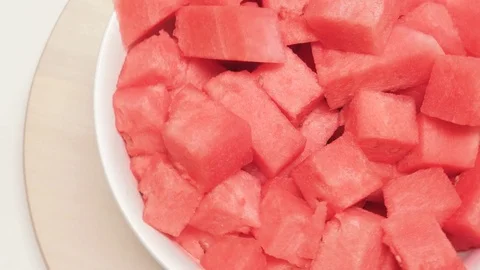 Birds Eye Shot of Watermelon in a Ceramic Serving Bowl on a Wooden Turntable Stock Footage 79385823