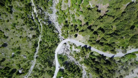 Bird's Eye top down of mountain road with car parked Stock Footage 128697037