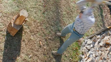 Birds Eye View of an Active Retiree Chopping Firewood in 4k Stock Footage 86079574