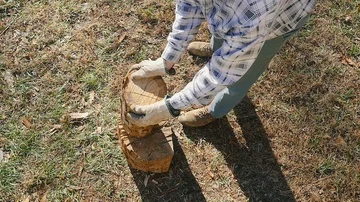 Birds Eye View of an Active Senior Man Placing a Log on a Block in Slow Motion Stock Footage 85571639