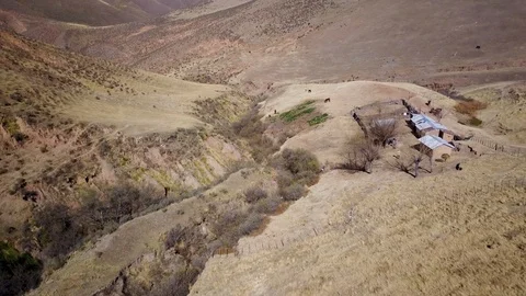 Birds Eye view of authentic mountain house and surroundings, `dolly aerial shot Stock Footage 89817703