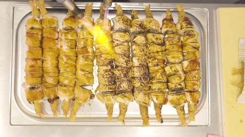 Bird's eye view of a chef torching sushi rolls Stock Footage 150964789