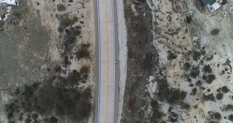 Birds eye view of cyclist going through small village drone aerial 4K Stock Footage 111308348